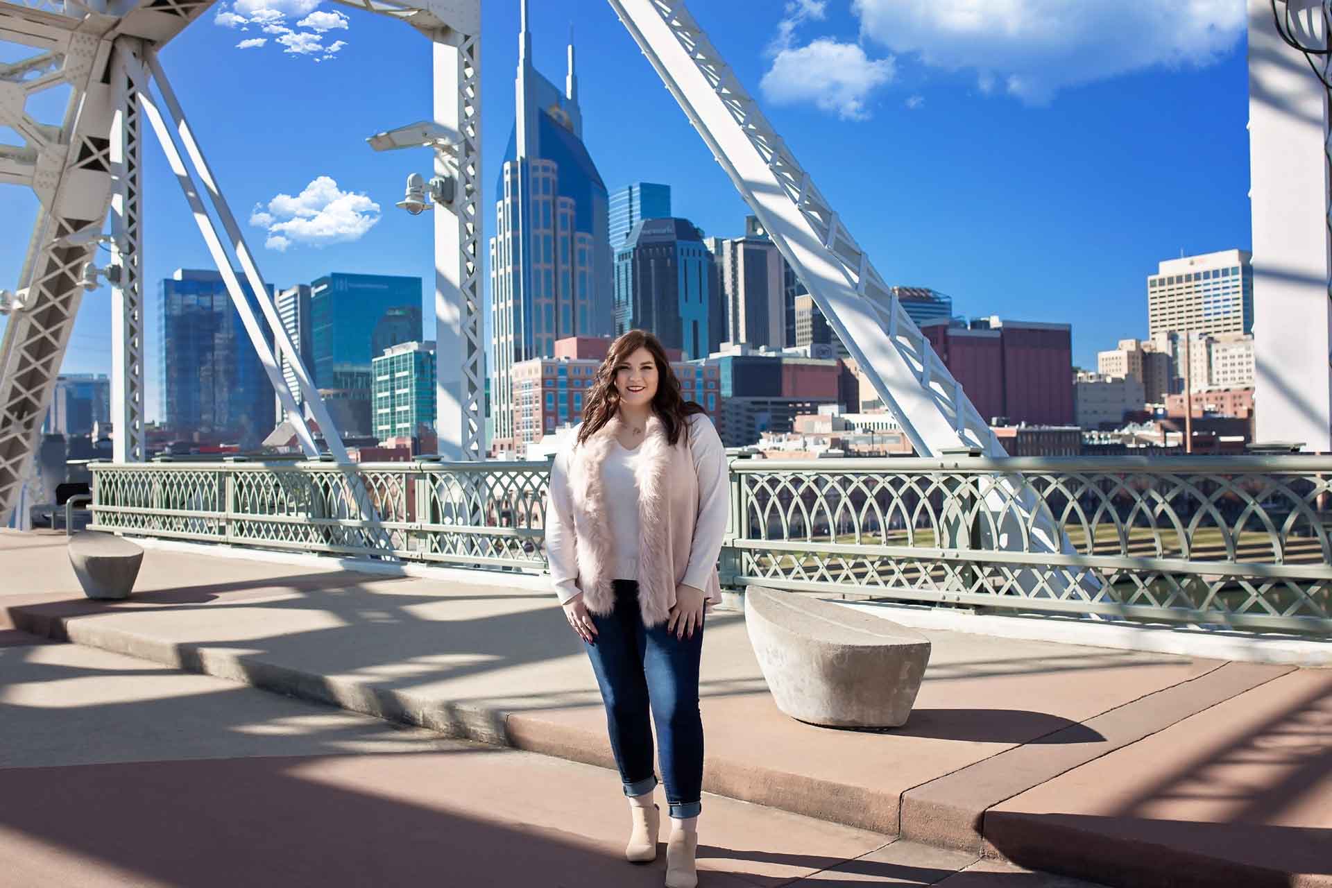 High School senior girl standing on the Nashville pedestrian bridge during a professional senior photography session at Moments By T, Franklin Tennessee 