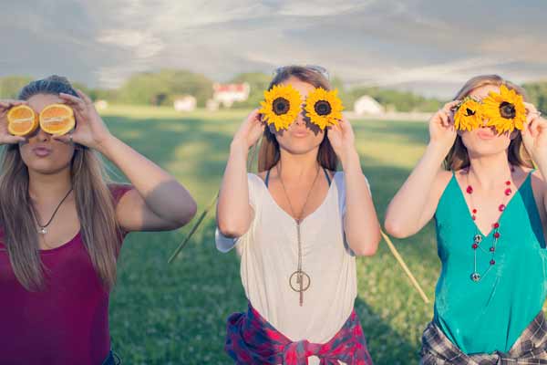 Teenage Girls Holding Sunflowers On Eyes in Franklin TN | Senior Photos Moments By T