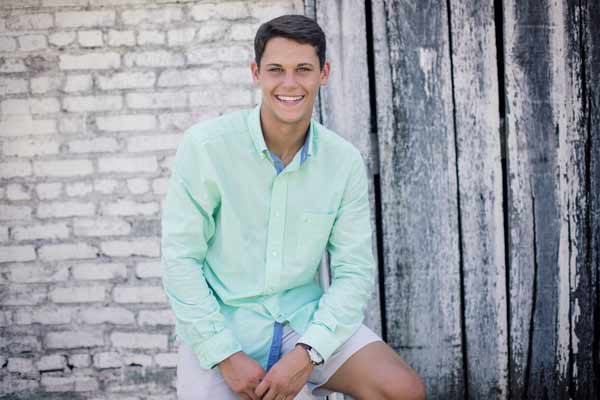 Senior Boy Sitting In Front Of Barn in Franklin TN | Senior Portraits Moments By T