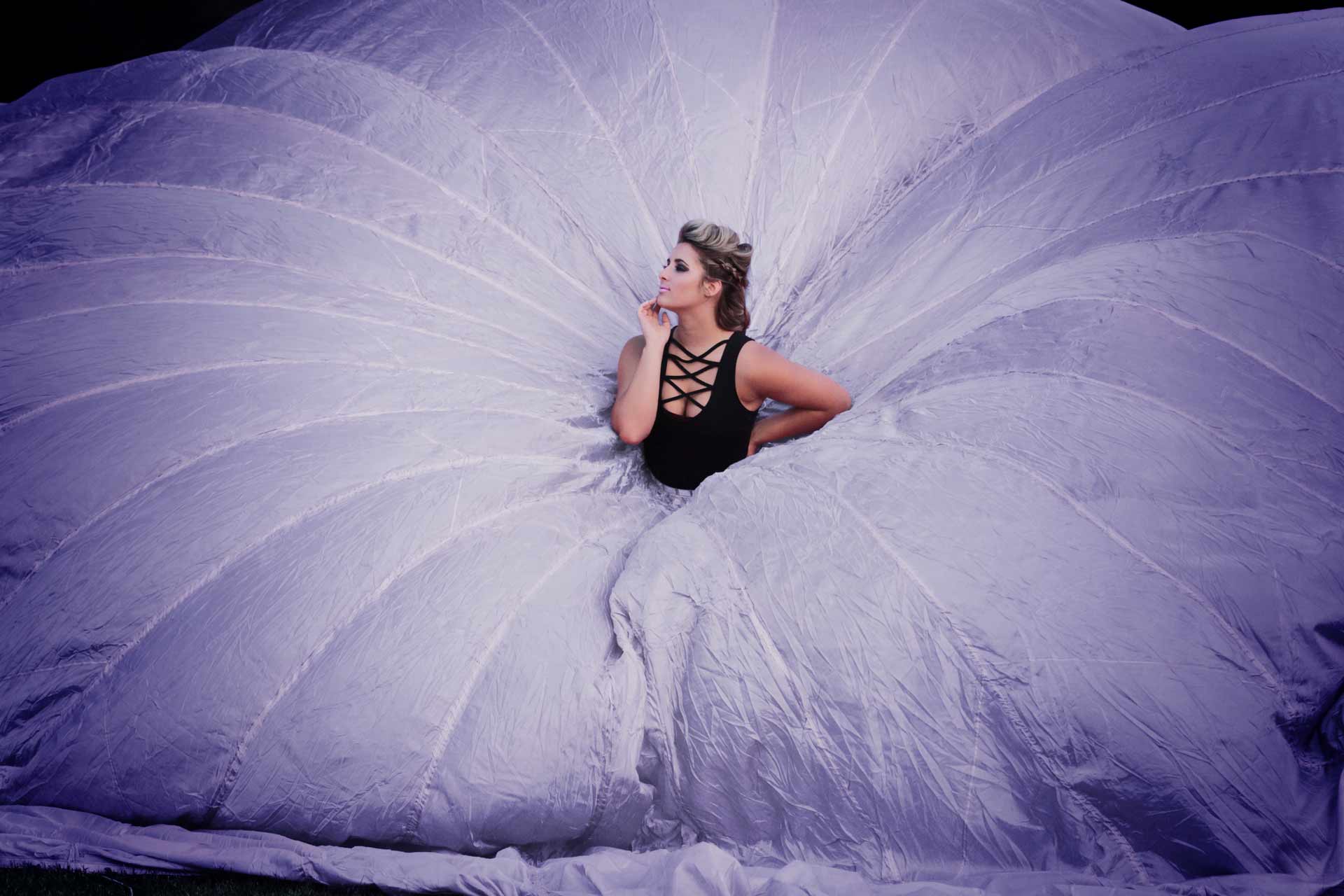 High School senior girl wearing a large purple parachute dress during professional senior photography session at Moments By T, Franklin Tennessee